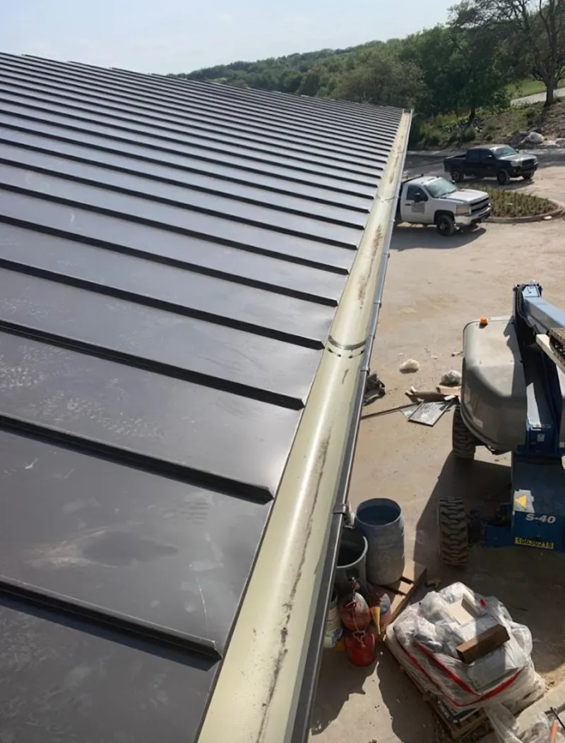Standing seam panel and gutter detail on a metal roofing jobsite in West Frankfort